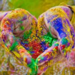 Close-up of colorful hands holding vivid Holi festival powder showcasing vibrant celebration.