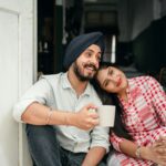 Happy Indian couple relaxing at home with coffee, embracing love and leisure. Perfect for lifestyle and relationship themes.