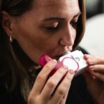 Close-up of a woman using an inhaler for respiratory health management.