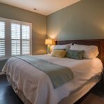 Stylish bedroom interior with cozy bed, elegant decor, and warm ambient lighting.